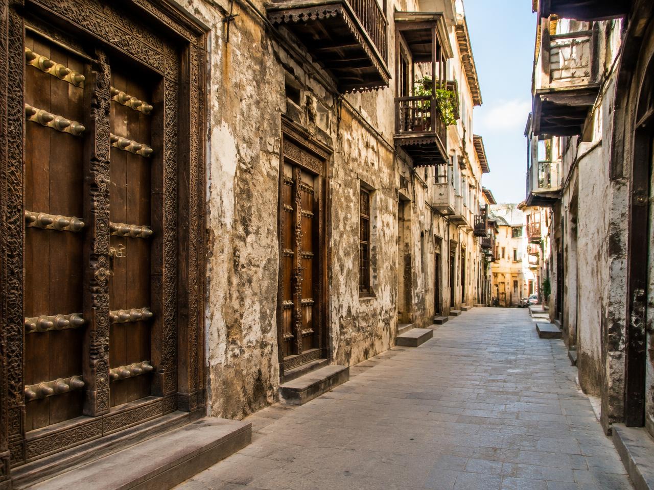 Illustrative Stone Town street with carved wooden doors